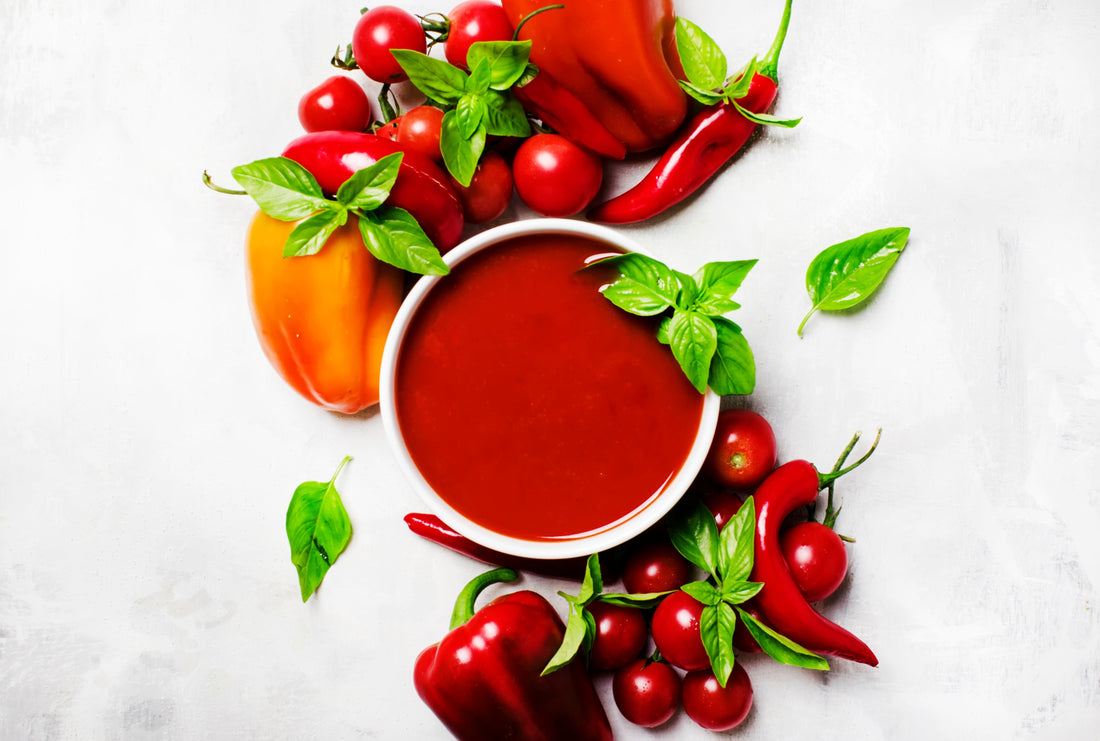 Bowl of spicy tomato soup with hot sauce